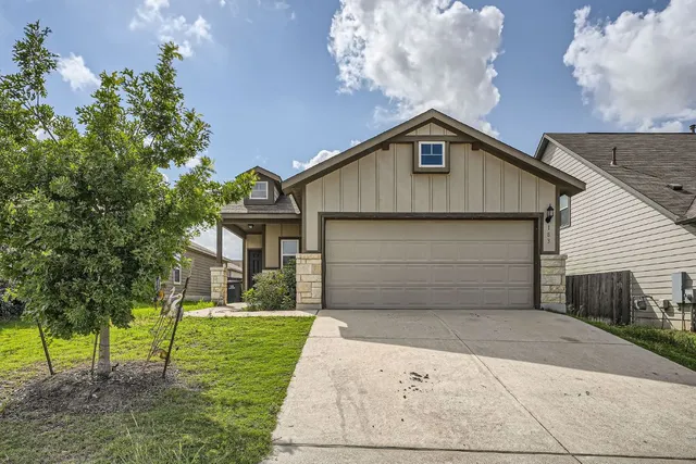 a view of a house with a yard and garage