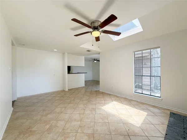 a view of a livingroom with a ceiling fan and window