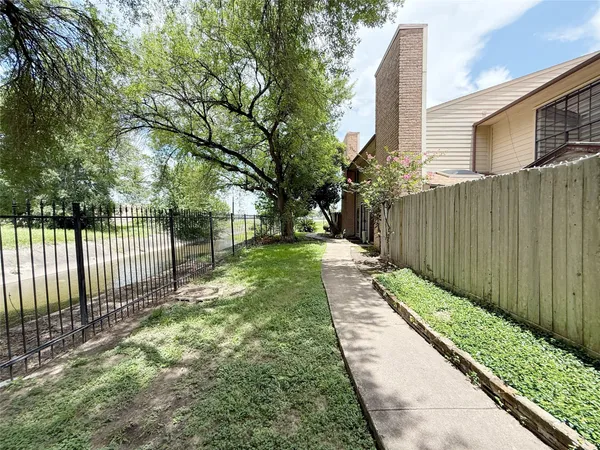 a view of a backyard with wooden fence