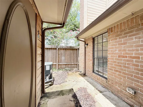 a view of a porch with wooden floor and front door