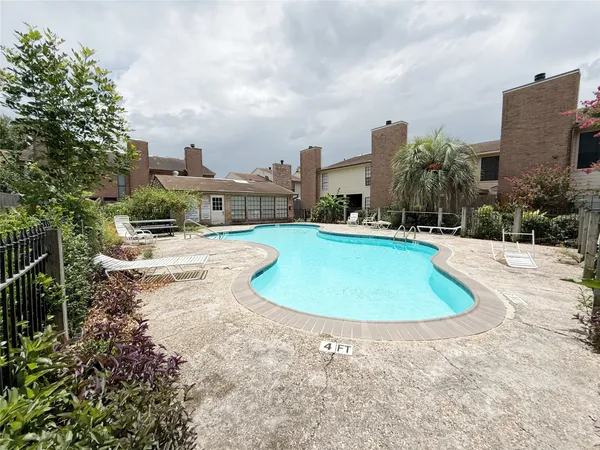 a view of a swimming pool and a yard