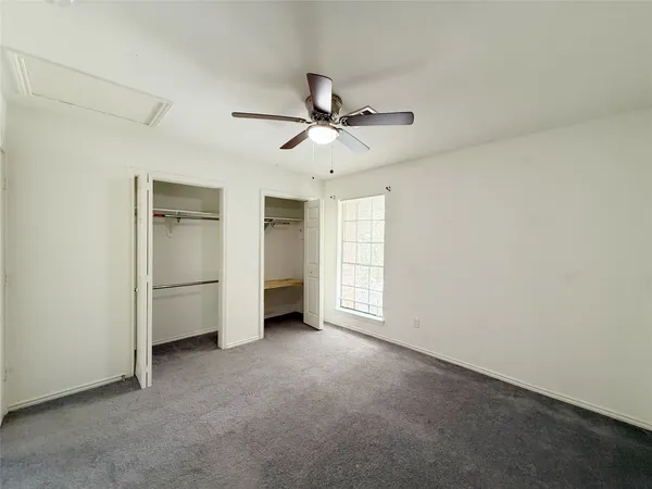 a view of a livingroom with an empty space and a ceiling fan