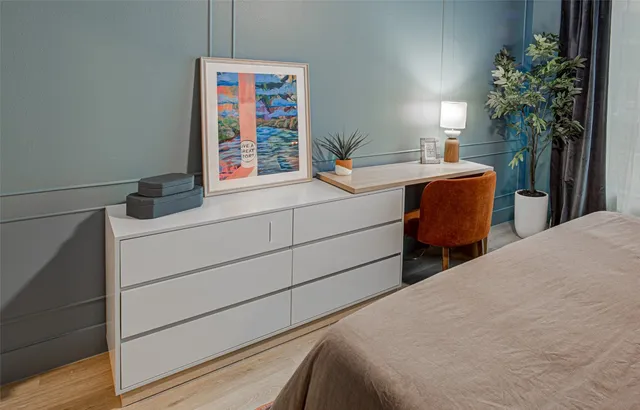 a bedroom with a bed and a potted plant