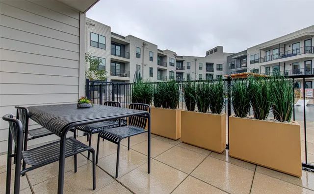 a view of a patio with a table and chairs