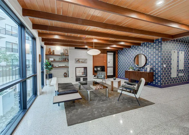 a living room with furniture and a potted plant
