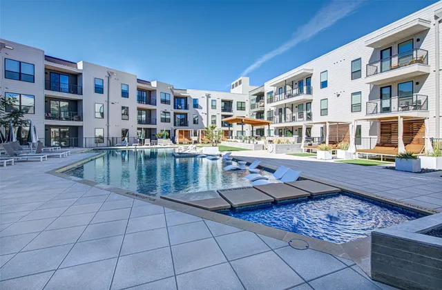 a view of a swimming pool with outdoor seating