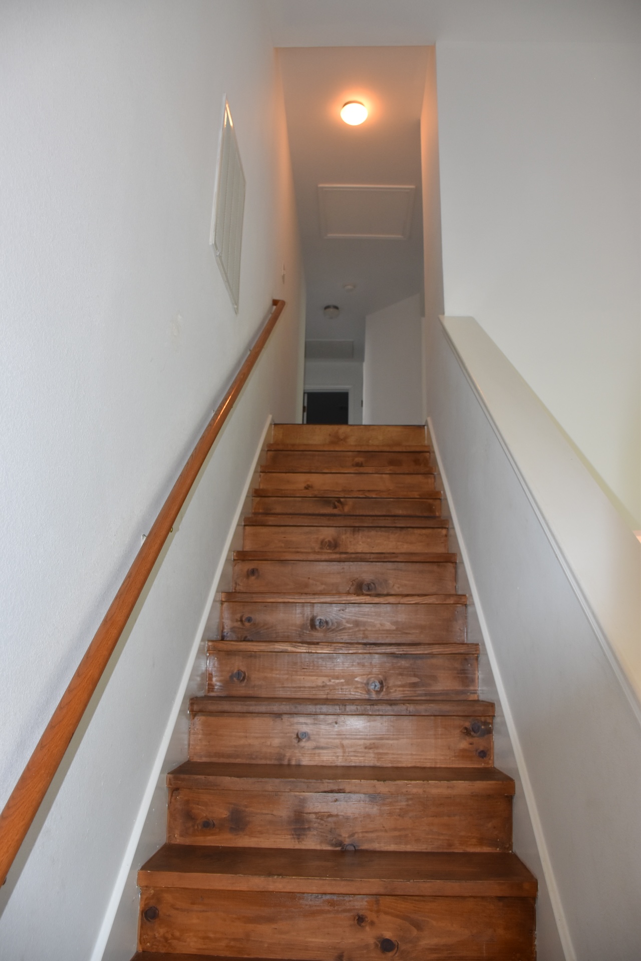 11300 Dimmit Street Manor, TX 78653 - Photo 14 of 23 Ascend to the upper level on these richly toned wood stairs, featuring a sleek wooden handrail.