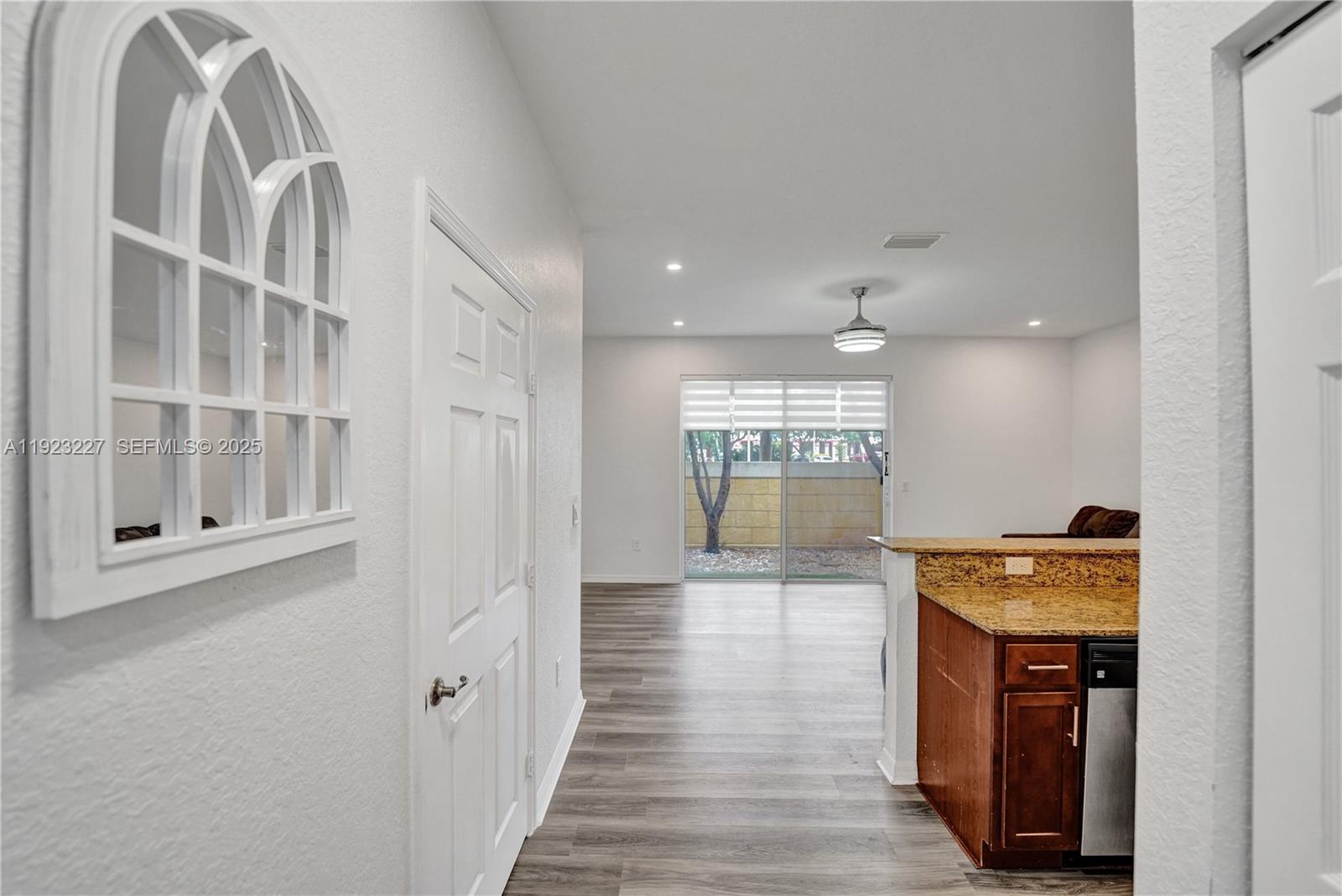 8993 Southwest 17th Court Miramar, FL 33025 - Photo 12 of 41 a hallway with wooden floor windows and entryway