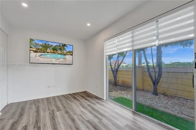 a view of room with window and wooden floor