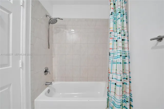 a bathroom with a bathtub and shower