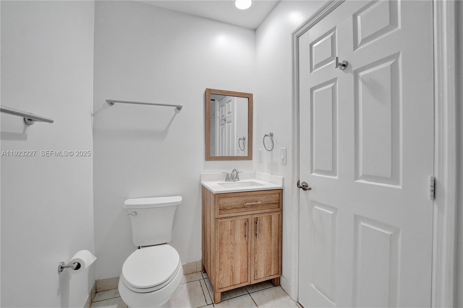 8993 Southwest 17th Court Miramar, FL 33025 - Photo 22 of 41 a bathroom with a toilet a sink and mirror