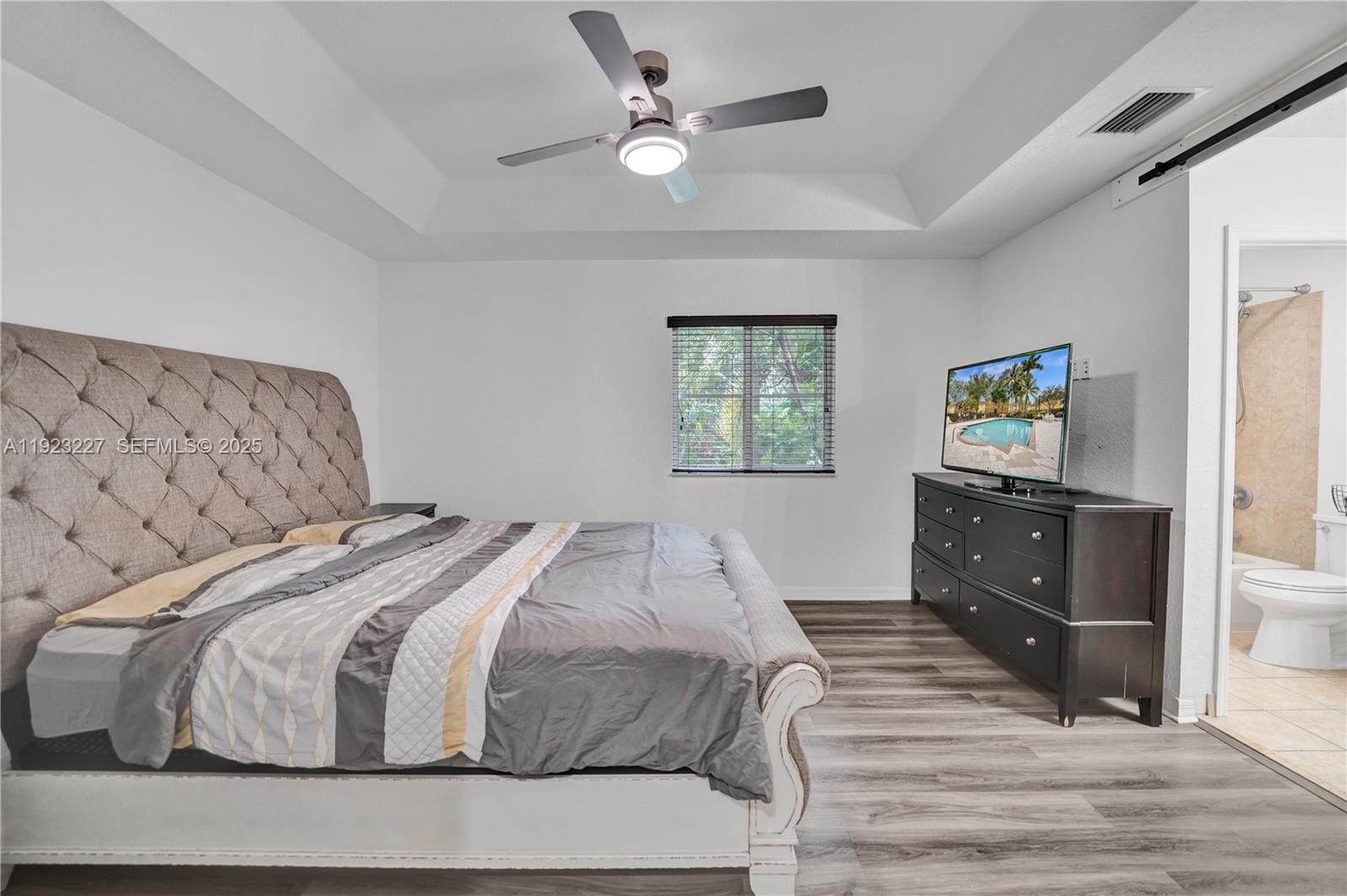 8993 Southwest 17th Court Miramar, FL 33025 - Photo 24 of 41 a bedroom with a bed and wooden floor