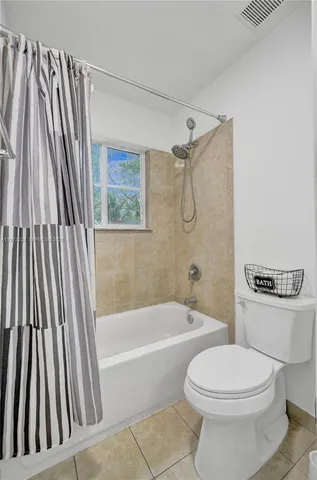 a bathroom with a toilet and a bathtub