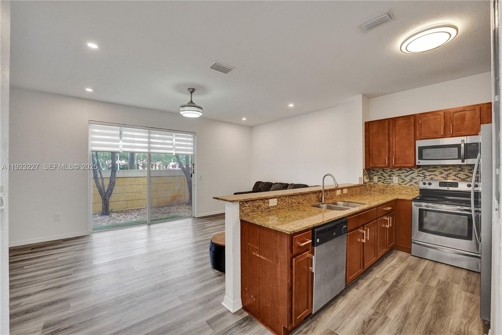 8993 Southwest 17th Court Miramar, FL 33025 - Photo 3 of 41 a kitchen with stainless steel appliances granite countertop a stove a sink and a refrigerator