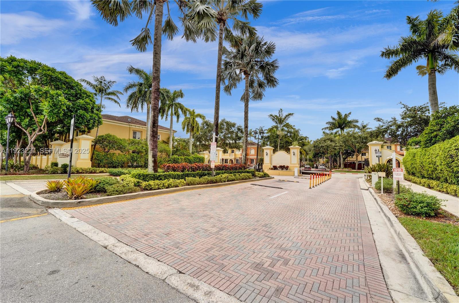 8993 Southwest 17th Court Miramar, FL 33025 - Photo 32 of 41 a view of a swimming pool with a lawn chairs and palm trees