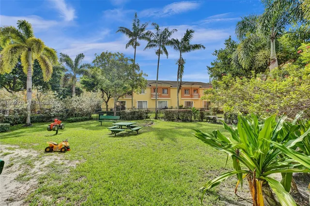 a view of a backyard with a table and chairs