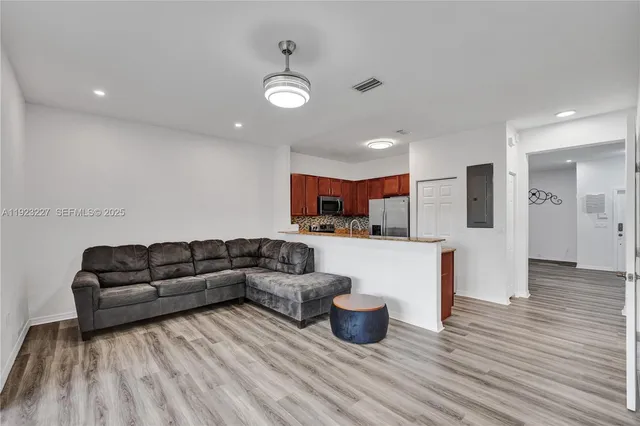 a living room with furniture and kitchen view