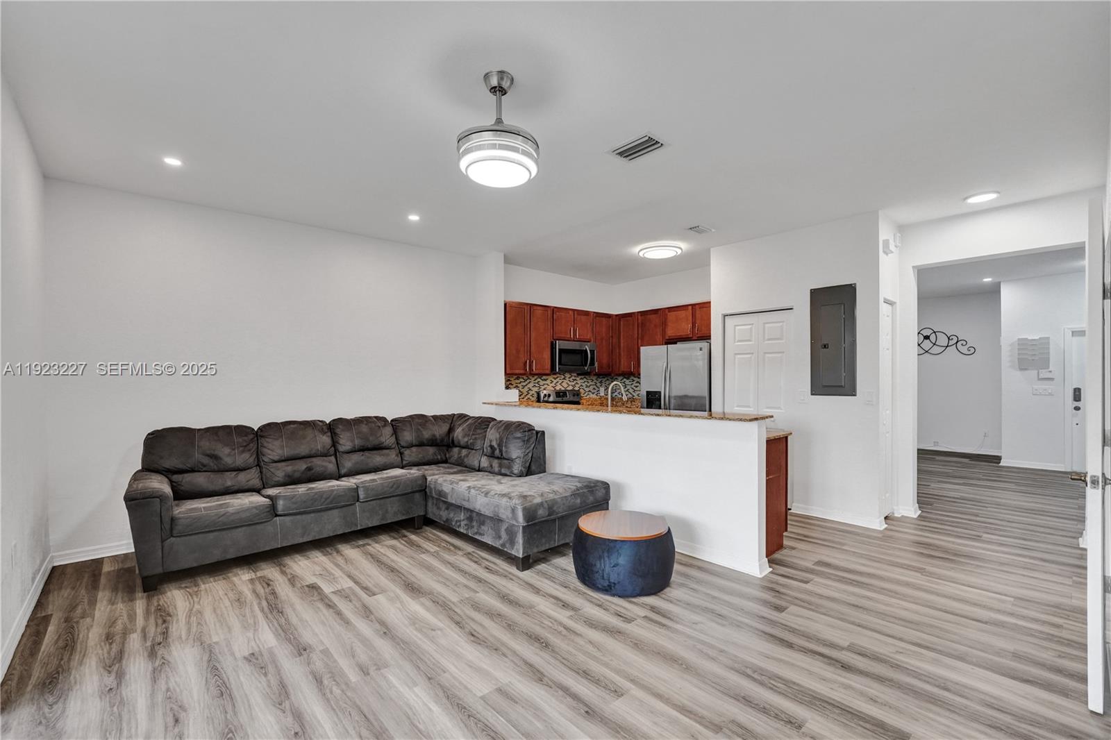 8993 Southwest 17th Court Miramar, FL 33025 - Photo 5 of 41 a living room with furniture and kitchen view