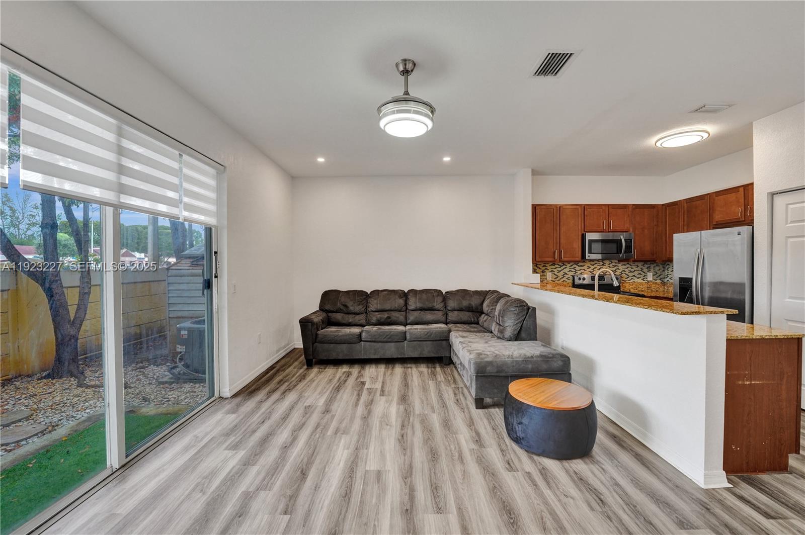 8993 Southwest 17th Court Miramar, FL 33025 - Photo 6 of 41 a living room with furniture and a potted plant