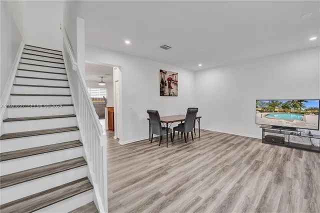 a view of a dining room with furniture and wooden floor
