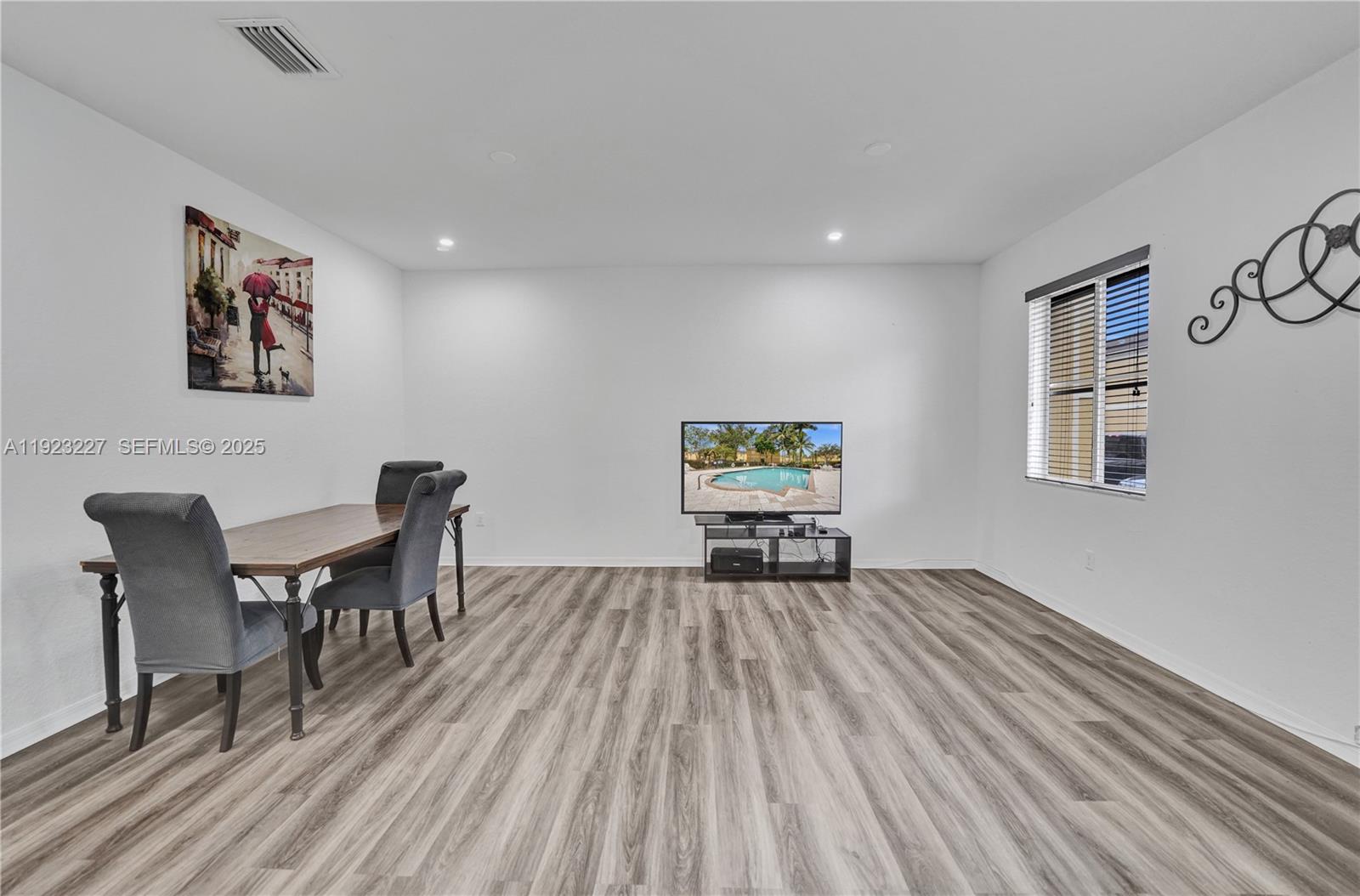 8993 Southwest 17th Court Miramar, FL 33025 - Photo 8 of 41 a workspace with furniture window and wooden floor