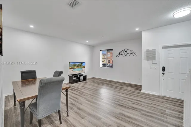 a view of a livingroom with furniture and wooden floor
