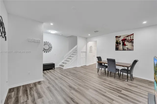 a view of a dining room with furniture and wooden floor