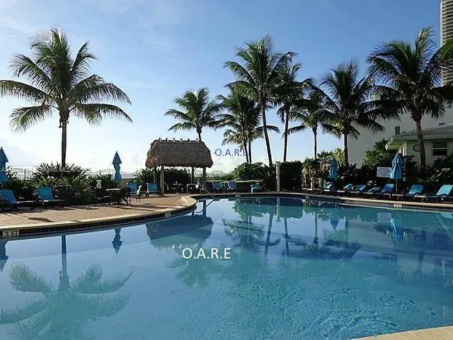 a view of swimming pool with table and chairs