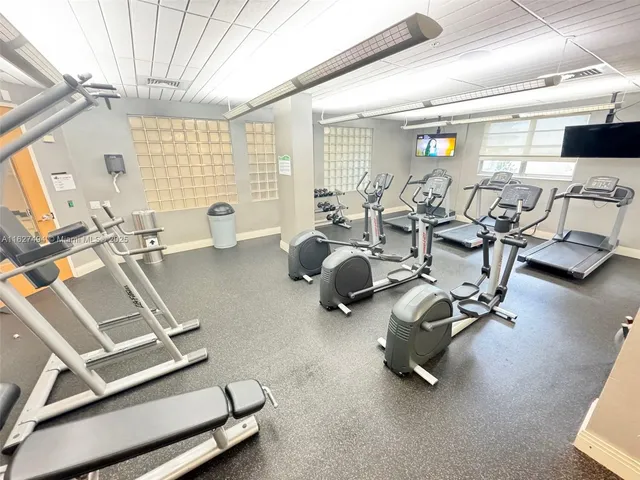 a room with gym equipment and a large window