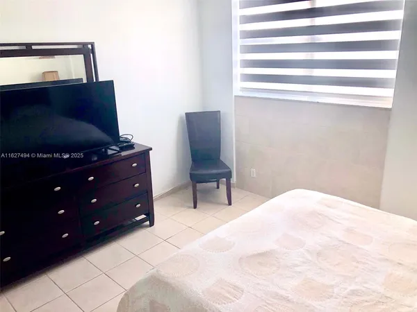 a bedroom with a bed and chair
