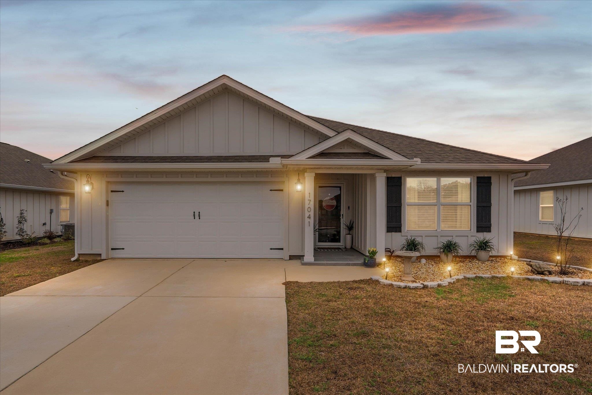 17041 Muse Street Loxley, AL 36551 - Photo 29 of 44 Ranch-style home featuring board and batten siding, driveway, an attached garage, a front lawn, and a shingled roof