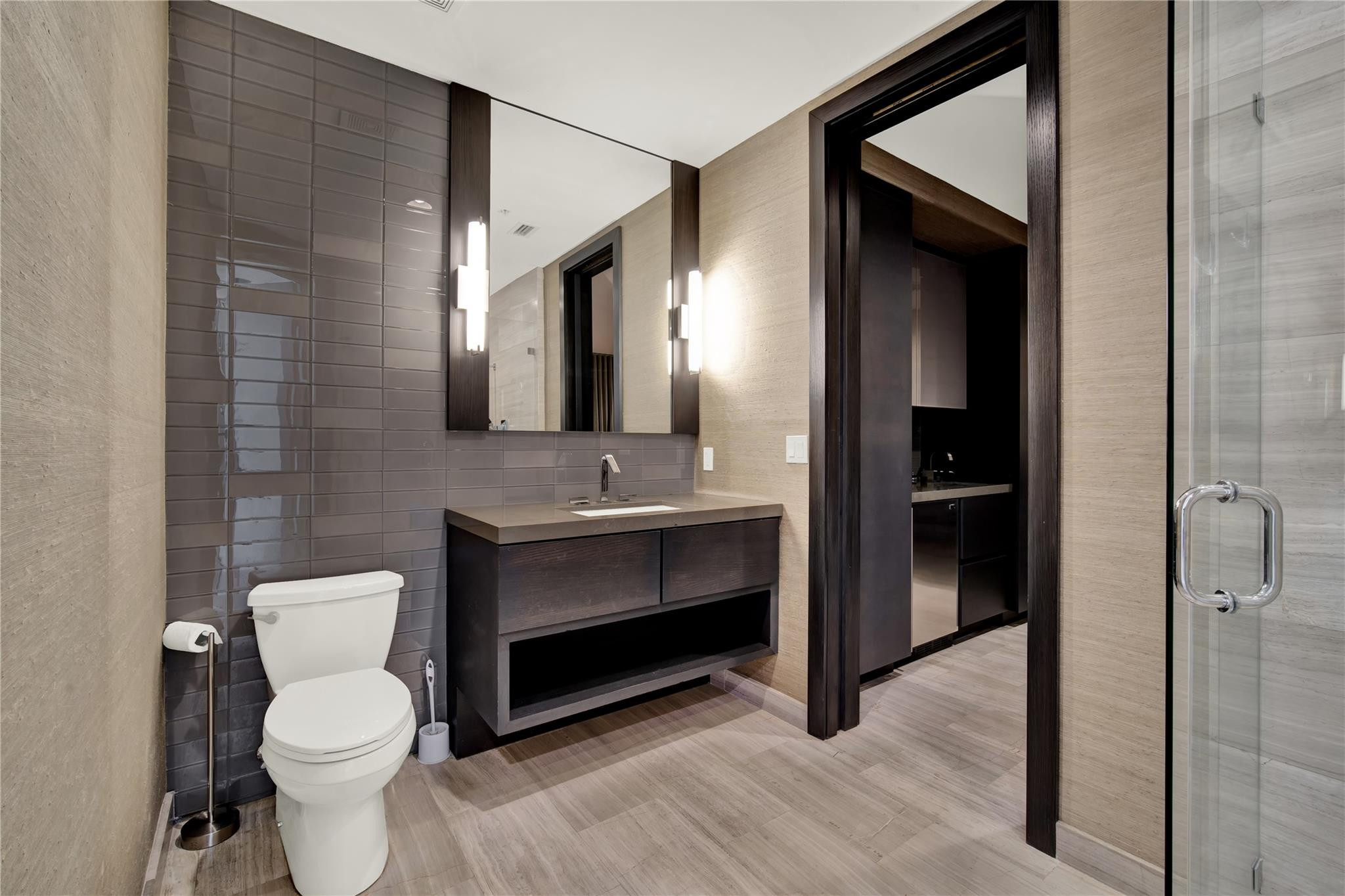 425 North Ocean Boulevard, Unit 3 Boca Raton, FL 33432 - Photo 9 of 69 a bathroom with a toilet sink and mirror