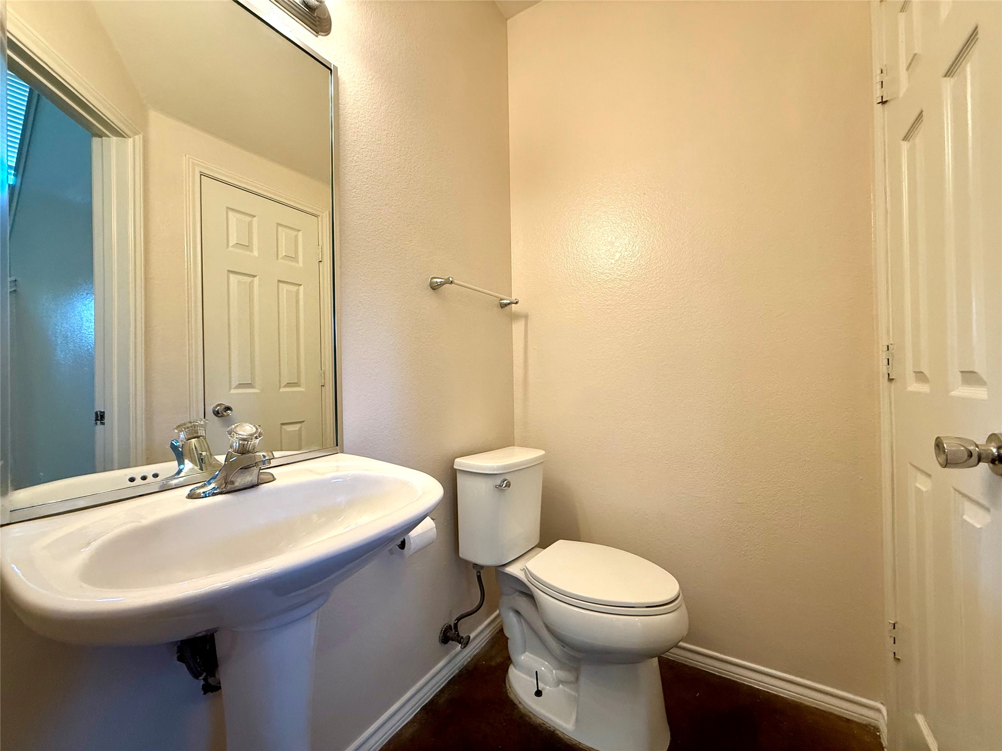 6912 Meador Avenue, Unit A Austin, TX 78752 - Photo 4 of 24 a bathroom with a sink a toilet and a mirror