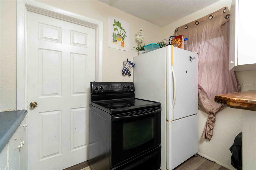 1142 7th Street Northwest Largo, FL 33770 - Photo 13 of 26 a kitchen with a refrigerator and a stove top oven