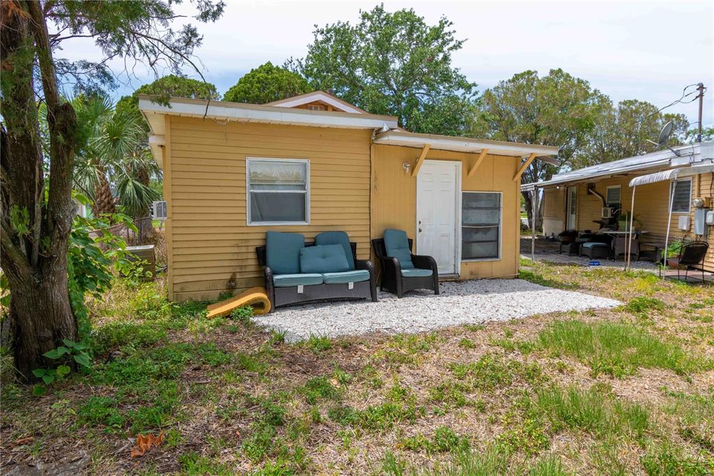1142 7th Street Northwest Largo, FL 33770 - Photo 23 of 26 a view of a backyard with chairs potted plants and a large tree