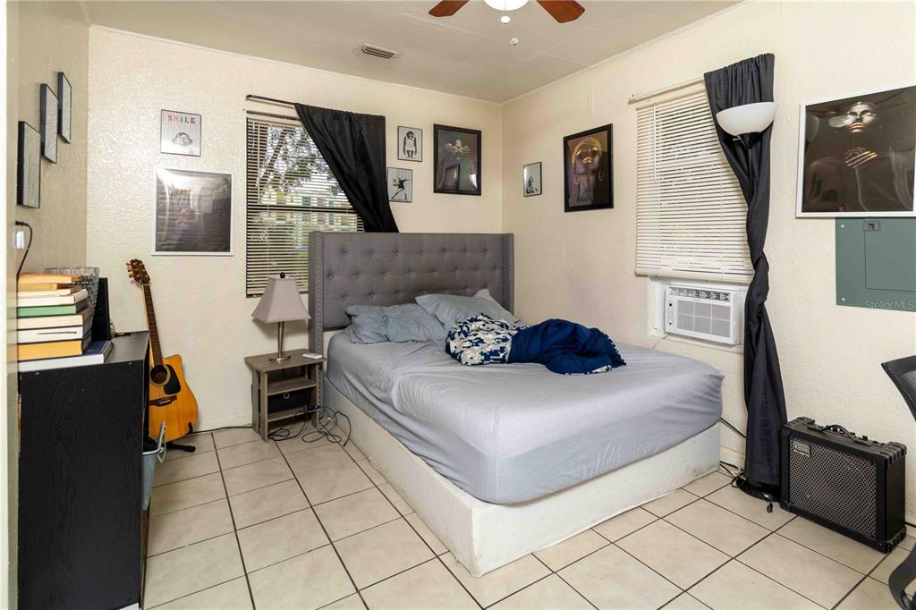 1142 7th Street Northwest Largo, FL 33770 - Photo 6 of 26 a bedroom with a bed and wooden floor