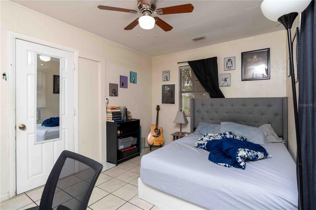 1142 7th Street Northwest Largo, FL 33770 - Photo 8 of 26 a bed room with furniture and a flat screen tv
