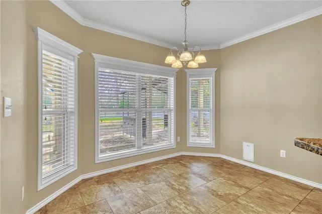a kitchen with granite countertop a sink a window and stainless steel appliances