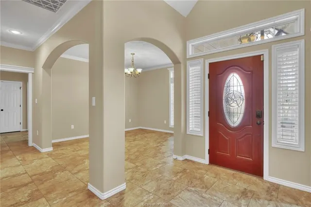 a dining room with furniture and chandelier