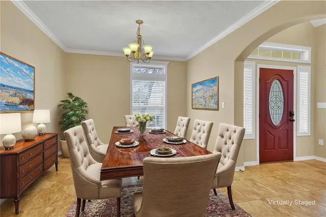 a view of an empty room with window and chandelier