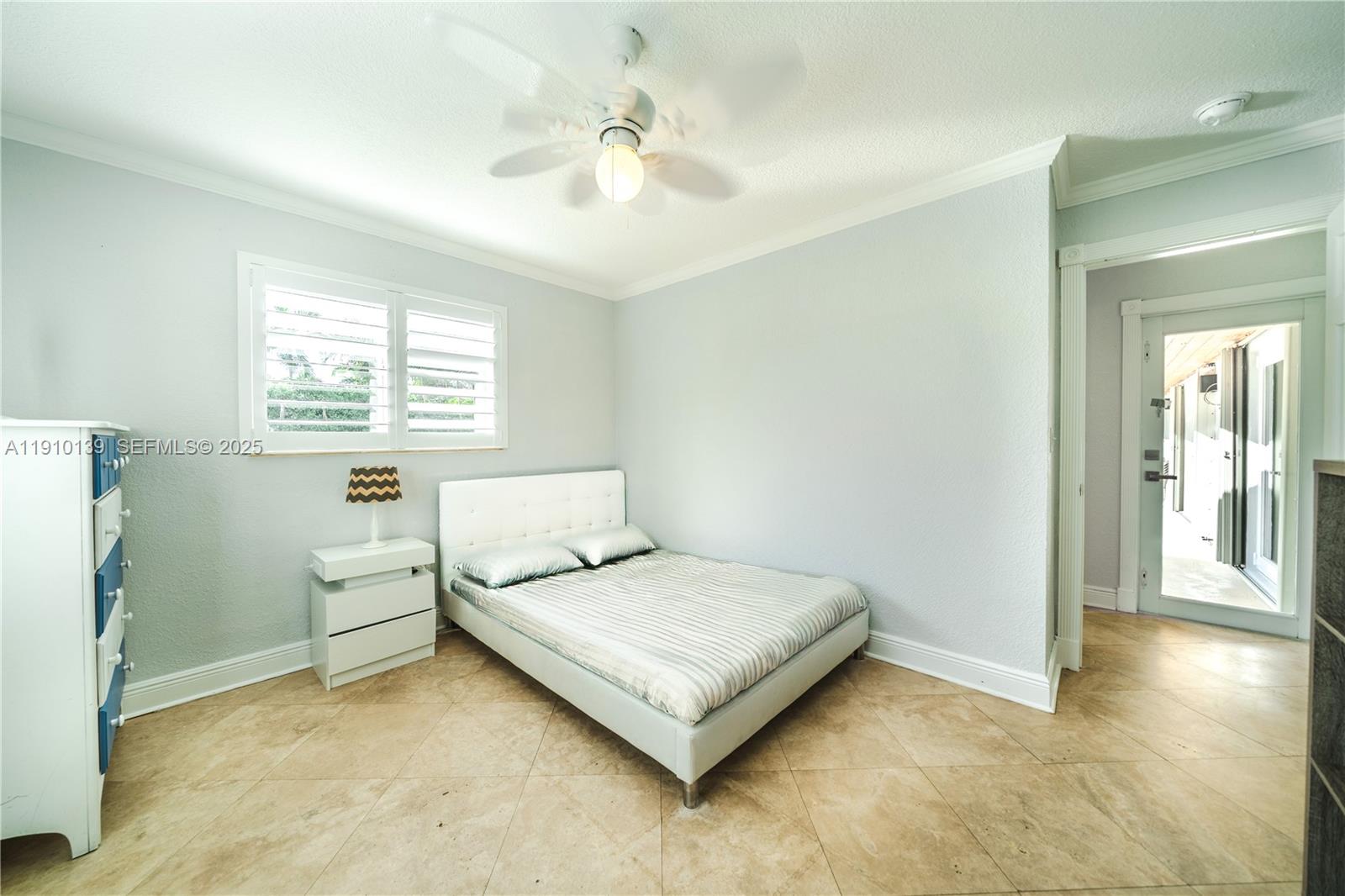 10320 Southwest 91st Street Miami, FL 33176 - Photo 21 of 30 a bedroom with a bed and a chandelier