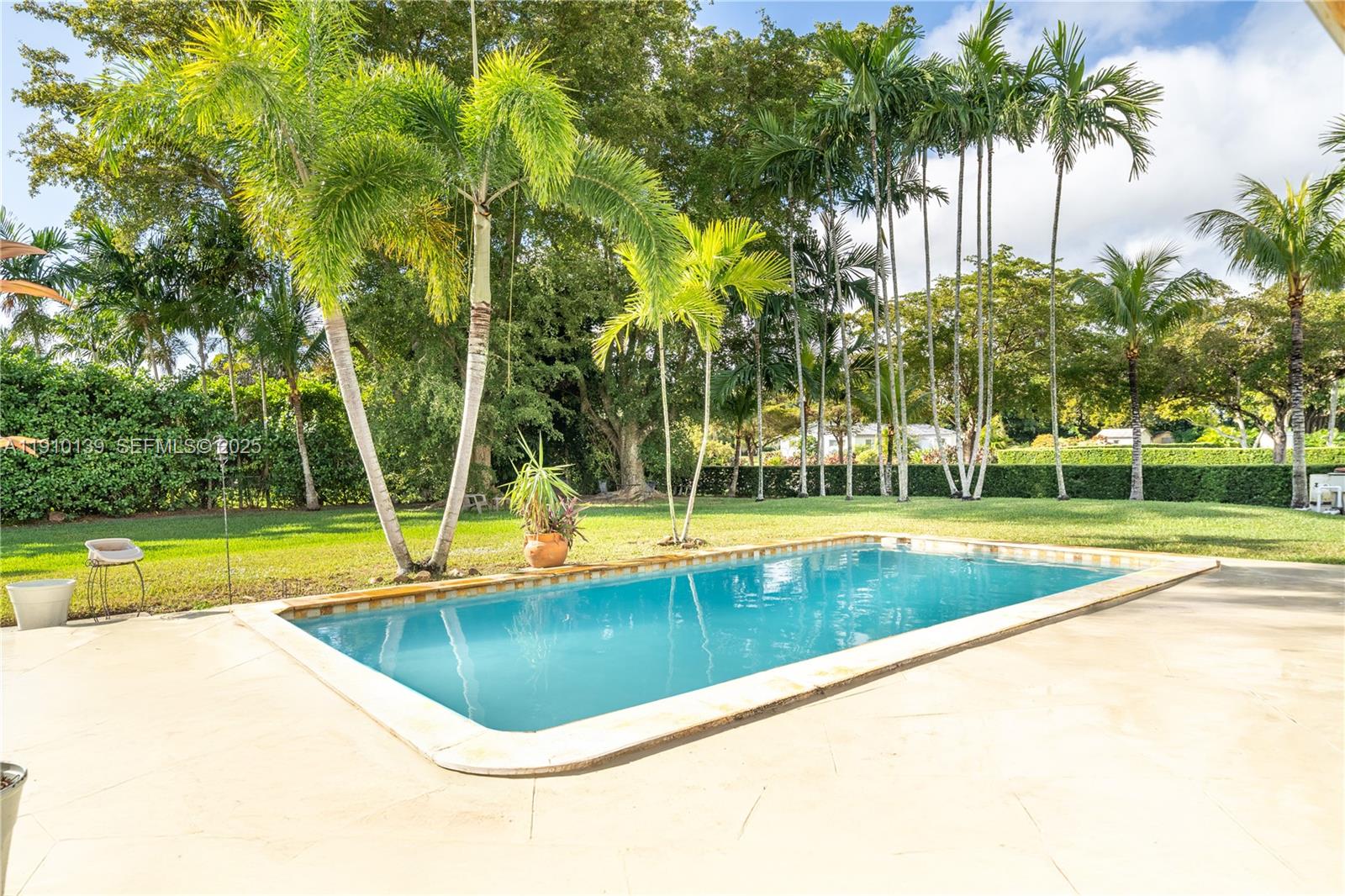 10320 Southwest 91st Street Miami, FL 33176 - Photo 24 of 30 a view of a swimming pool with a yard and palm trees