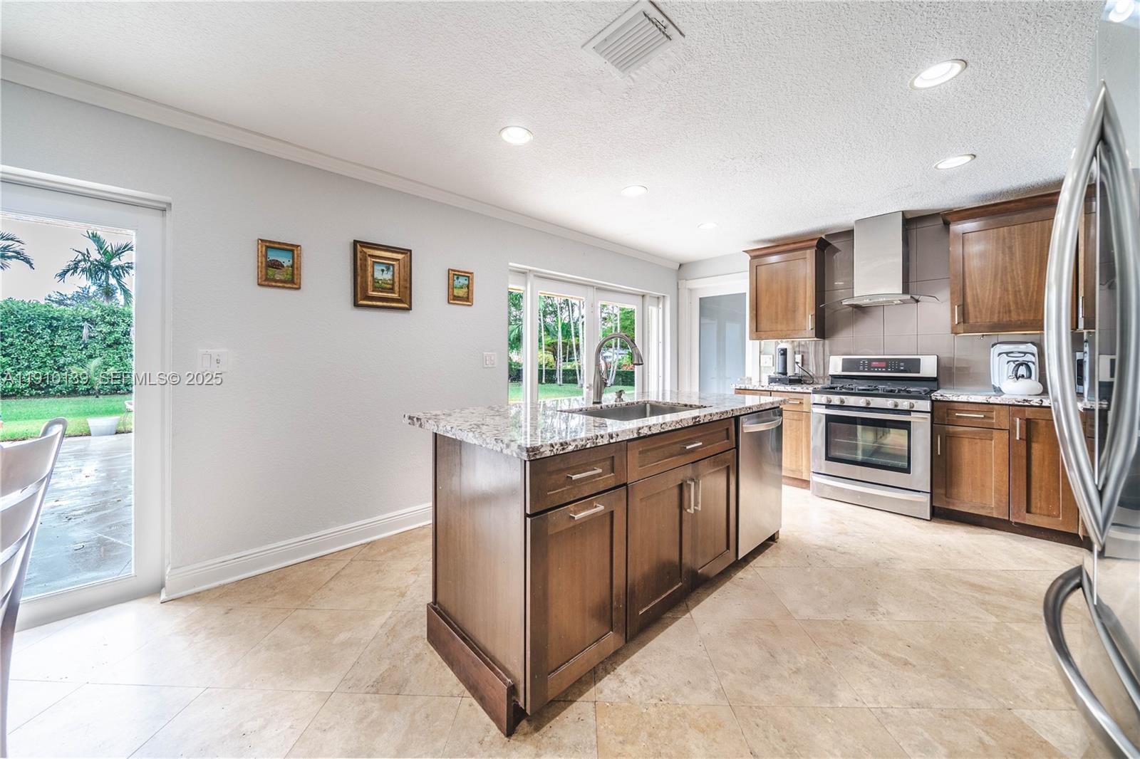 10320 Southwest 91st Street Miami, FL 33176 - Photo 10 of 30 a kitchen with stainless steel appliances granite countertop a stove a sink and a refrigerator