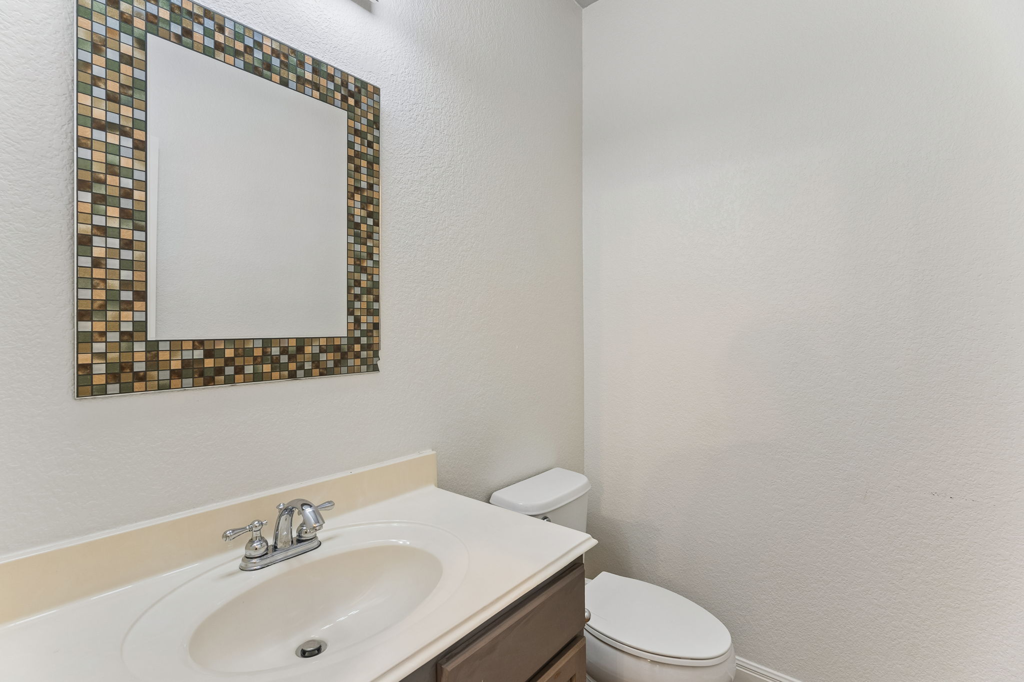 114 Aria Ridge, Unit 802 Lakeway, TX 78738 - Photo 12 of 37 A well-appointed bathroom vanity with a decorative mirror offers functional elegance.