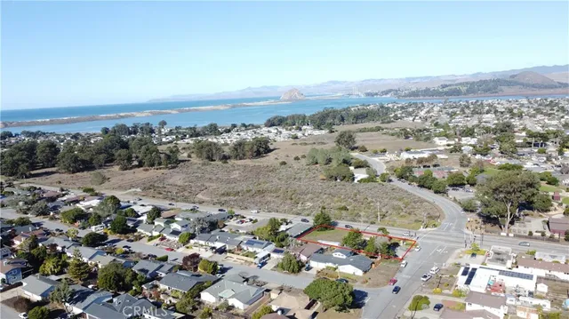 an aerial view of house with green space