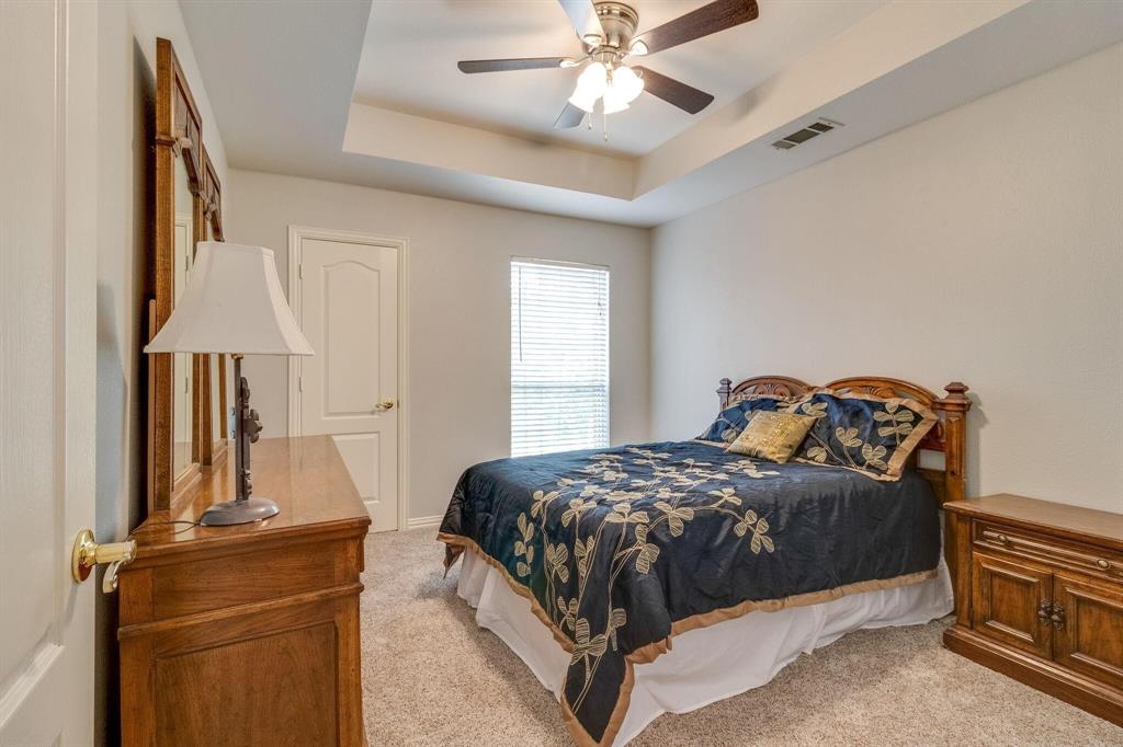 18 Greenleaf Drive Trophy Club, TX 76262 - Photo 16 of 25 a bedroom with a bed and a chandelier