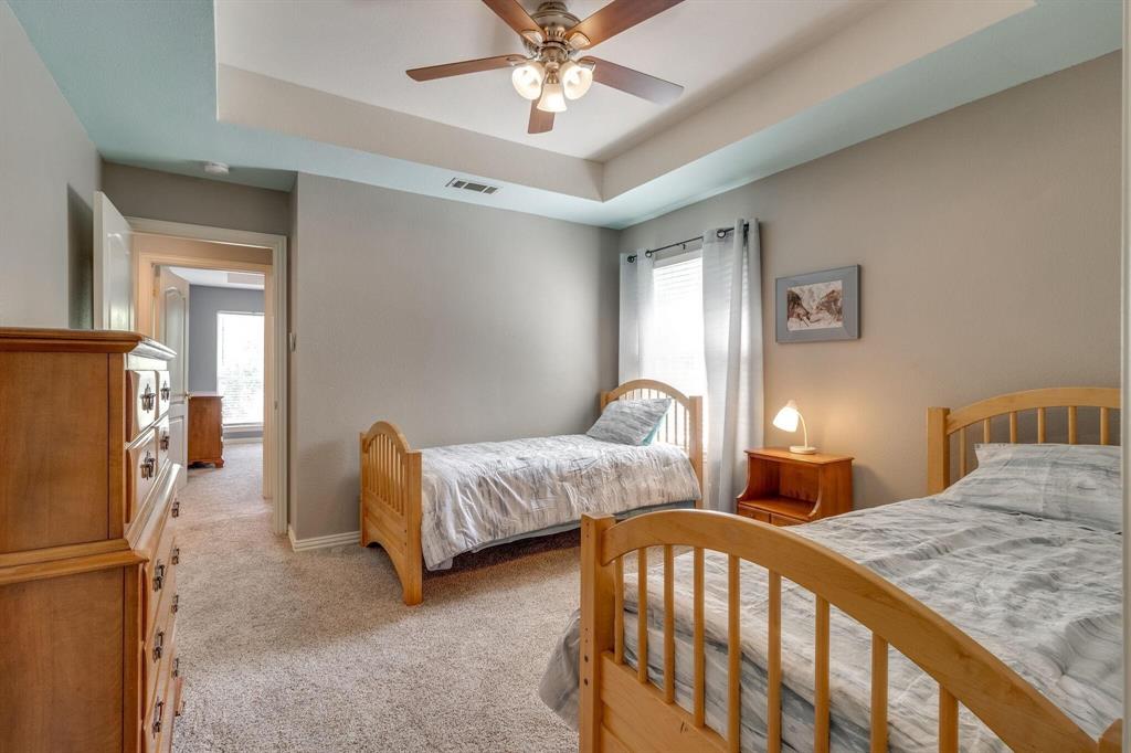 18 Greenleaf Drive Trophy Club, TX 76262 - Photo 17 of 25 a bedroom with a bed and a chandelier