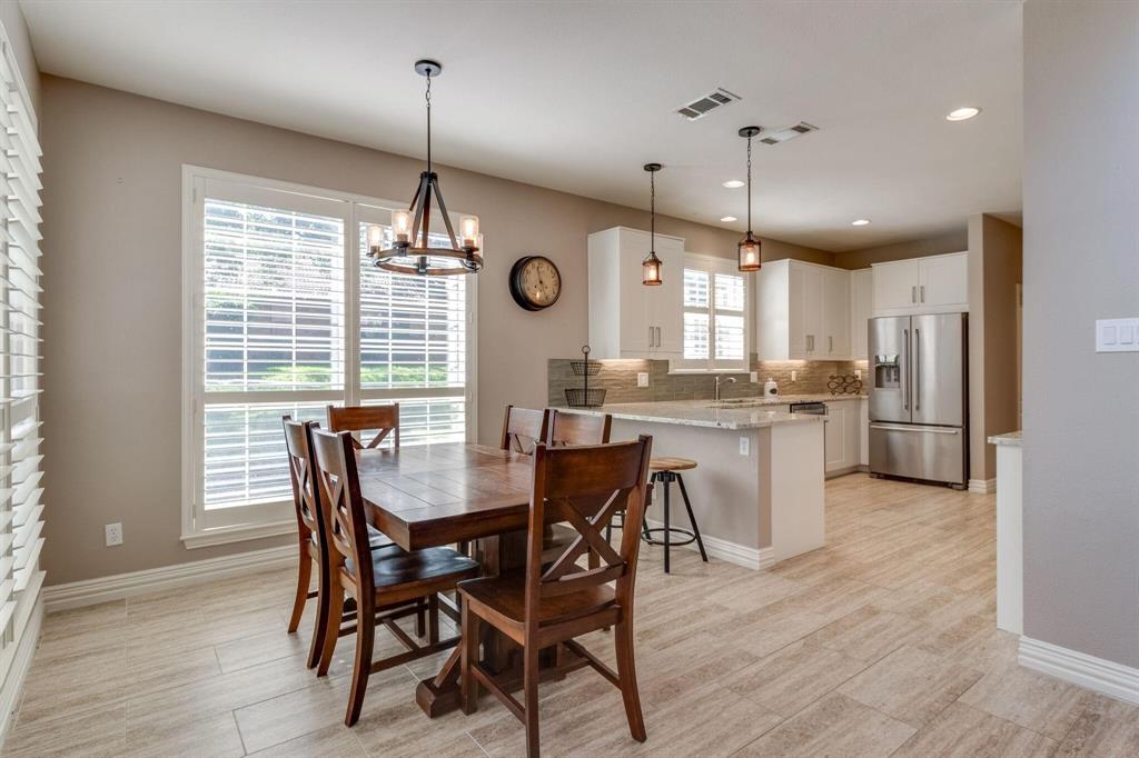 18 Greenleaf Drive Trophy Club, TX 76262 - Photo 9 of 25 a view of a dining room and livingroom with furniture wooden floor a chandelier