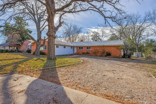 a view of a yard with a large tree