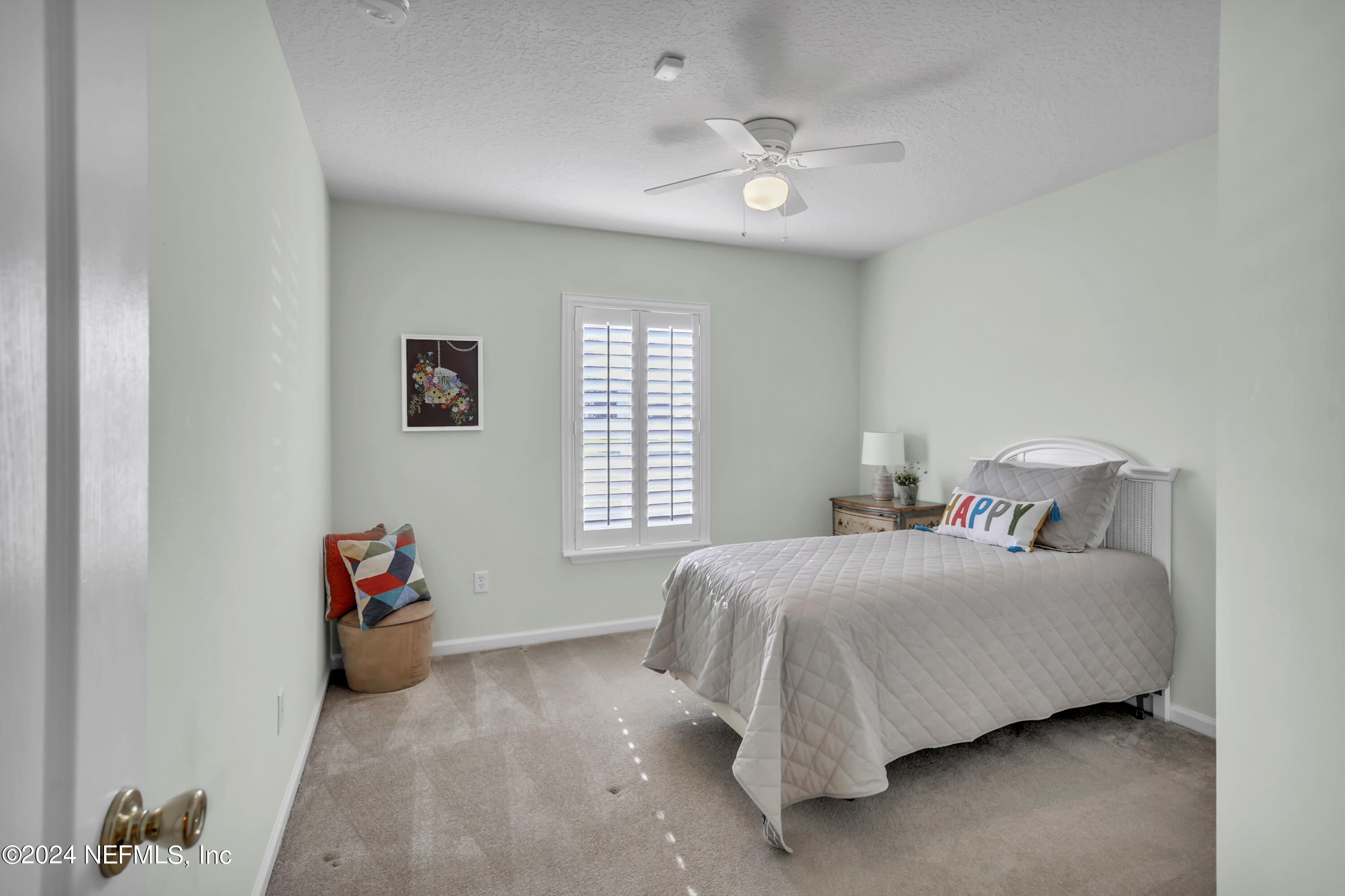 1184 Nochaway Drive St. Augustine, FL 32092 - Photo 19 of 39 a bedroom with a bed and a chandelier